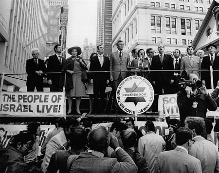 Sunday, October 14, 1973: At the Freedom Rally for Israel at City Hall in New York City.  Singing Hatikva, Israel's national anthem, are (left to right): Hon. Paul O'Dwyer; former Prisoner of Conscience Arkady Voloshin; Rep. Bella Abzug (D-NY); Mayor John V. Lindsay; Jo Amar; Greater New York Conference on Soviet Jewry Chairman Stanley H. Lowell; Israeli Foreign Minister Abba Eban; City Council president Sanford Garelick; Greater New York Conference on Soviet Jewry treasurer Samuel Hausman; American Zionist Federation president Rabbi Israel Miller. 